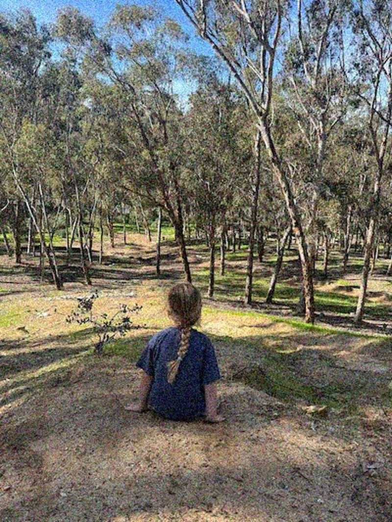 Original: grainy phone photo of a child in a park