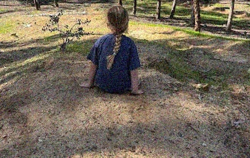Original: grainy park photo of a child sitting on dirt